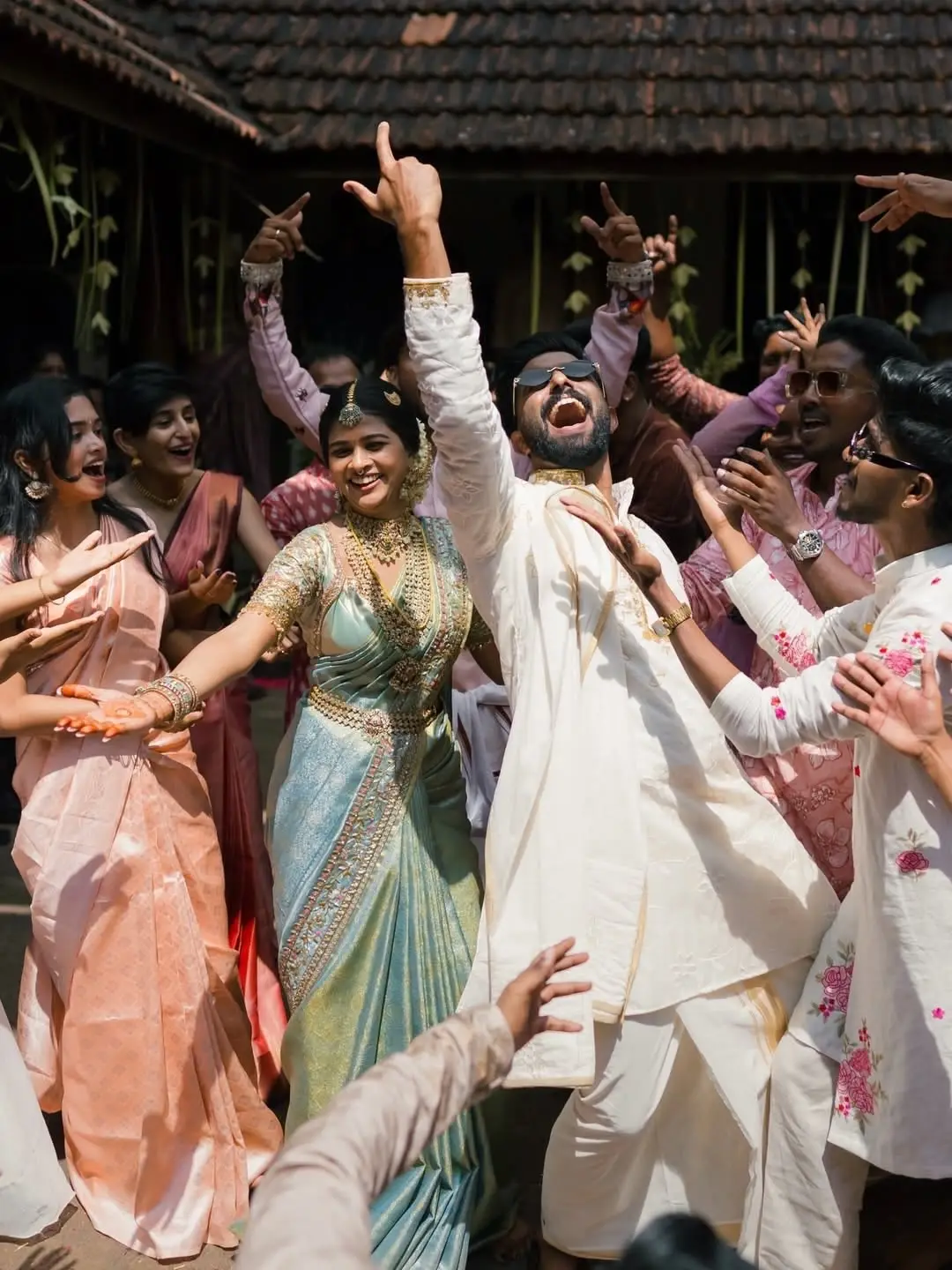 The bride and groom dancing, surrounded by guests